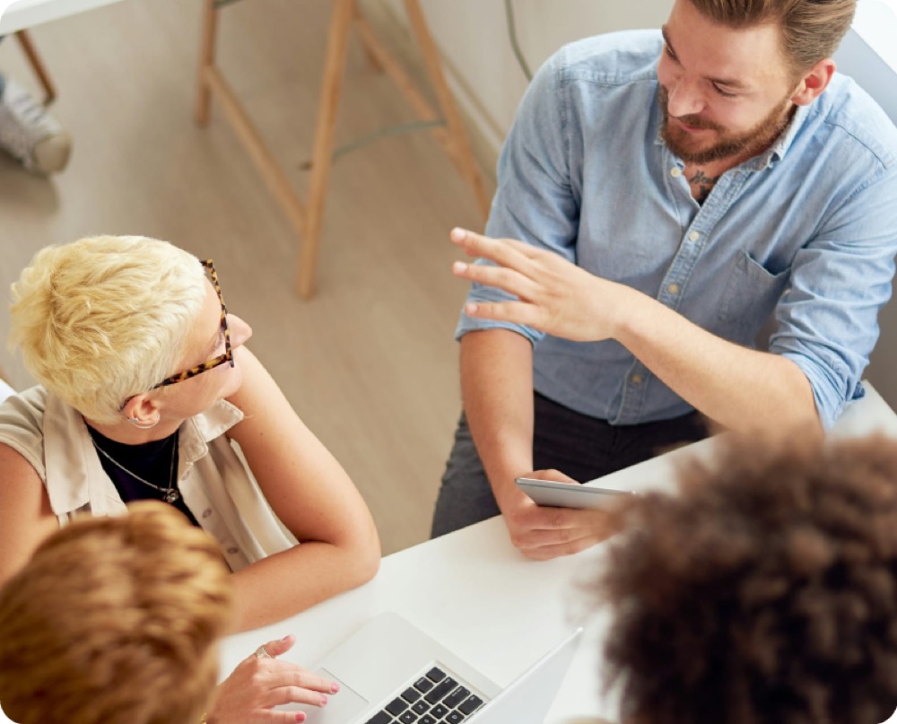 Adult learners collaborating around a table