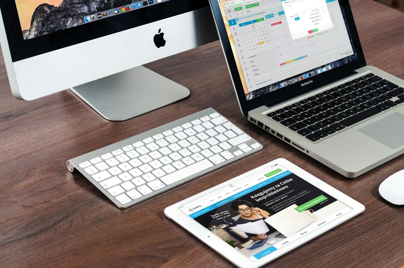 Desktop computer, laptop and tablet on a desk