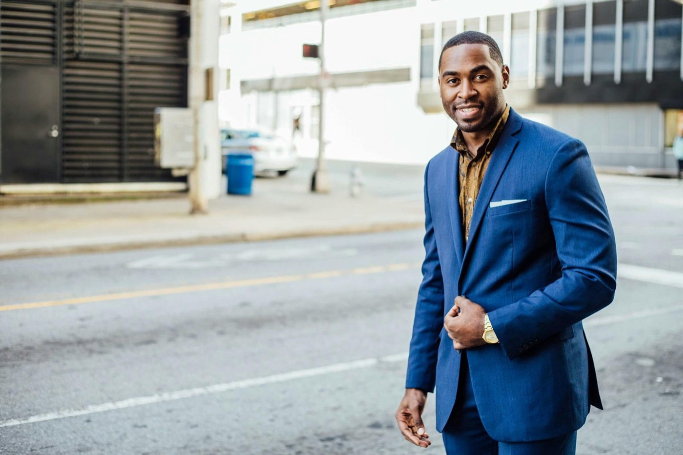Professional in a blue suit standing on a city street