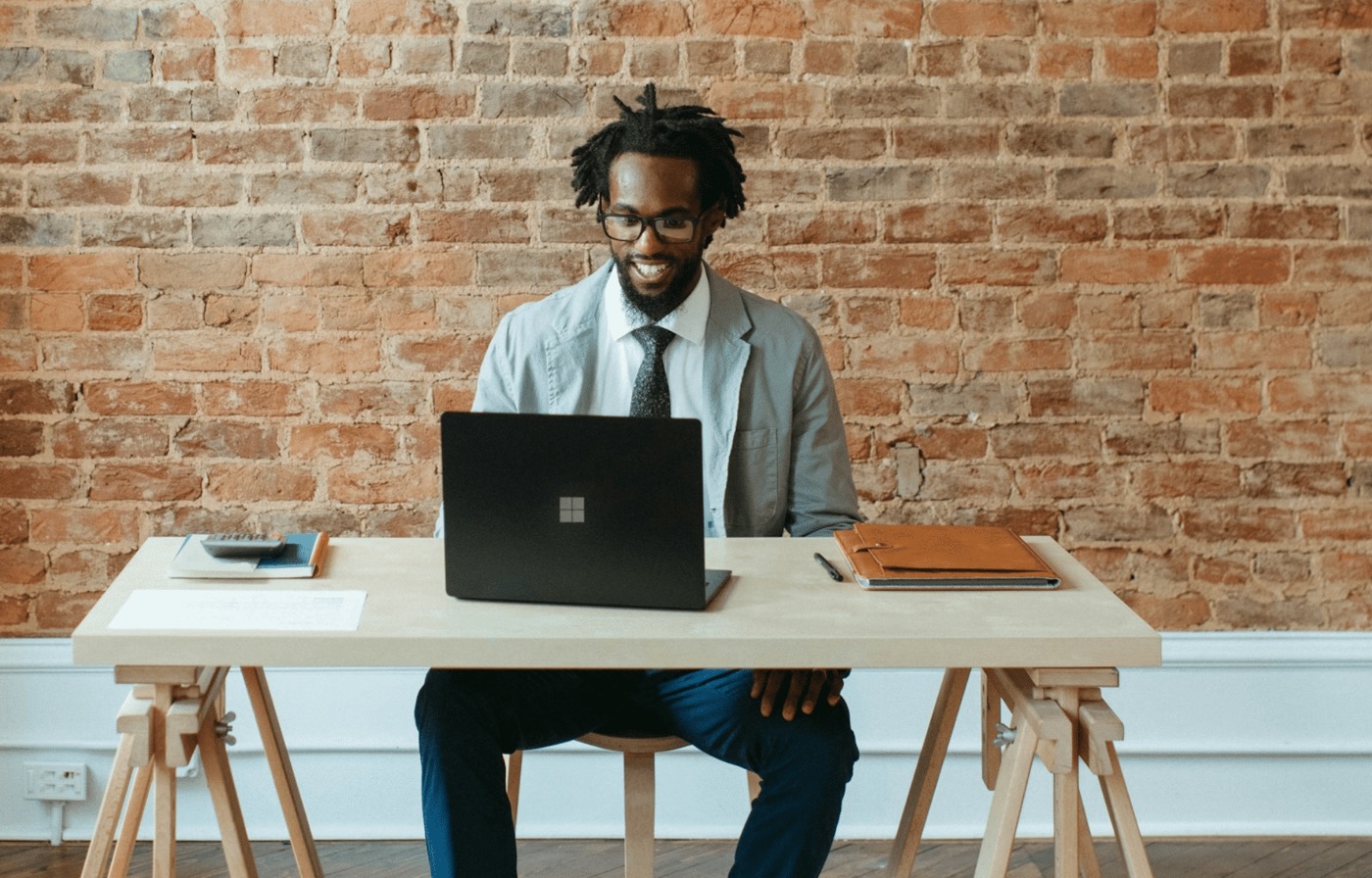 Smiling professional working at a laptop